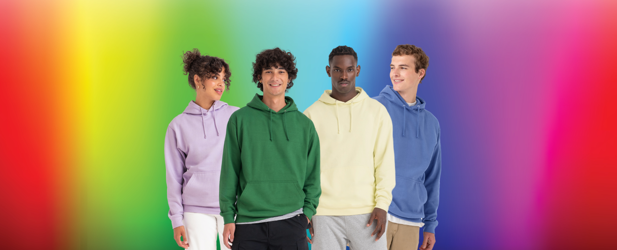 Four models wearing hoodies on a rainbow background