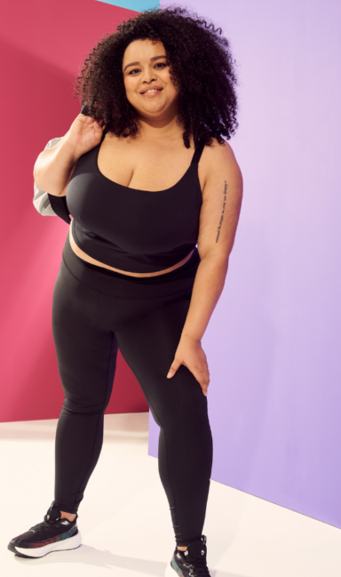 Female model wearing matching sports bra and leggings set
